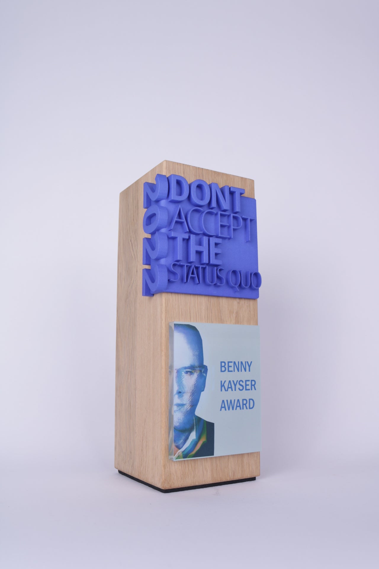 wooden trophy with a blue 3d printed cornertext