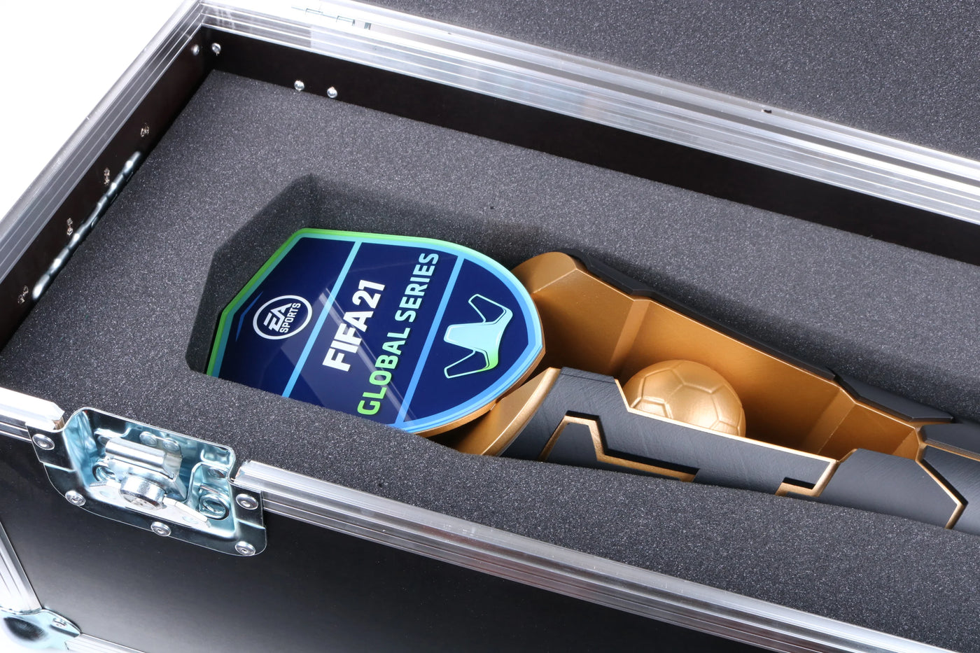 gold and black trophie with a golden ball and a blue and green acrylic template for fifa
