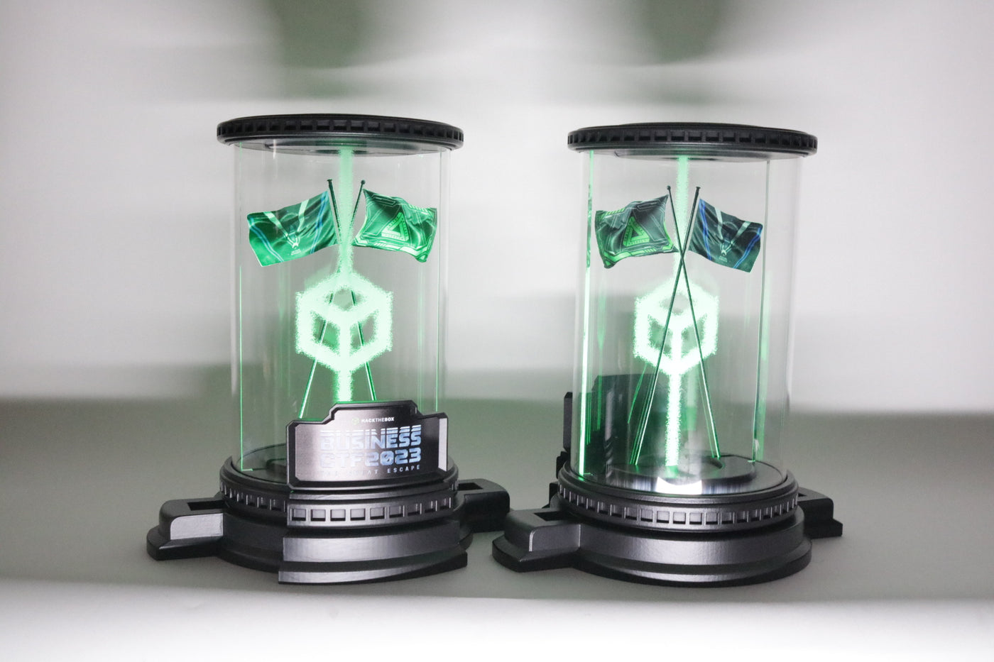black 3d printed base with green flags and a cilinder for hack the box