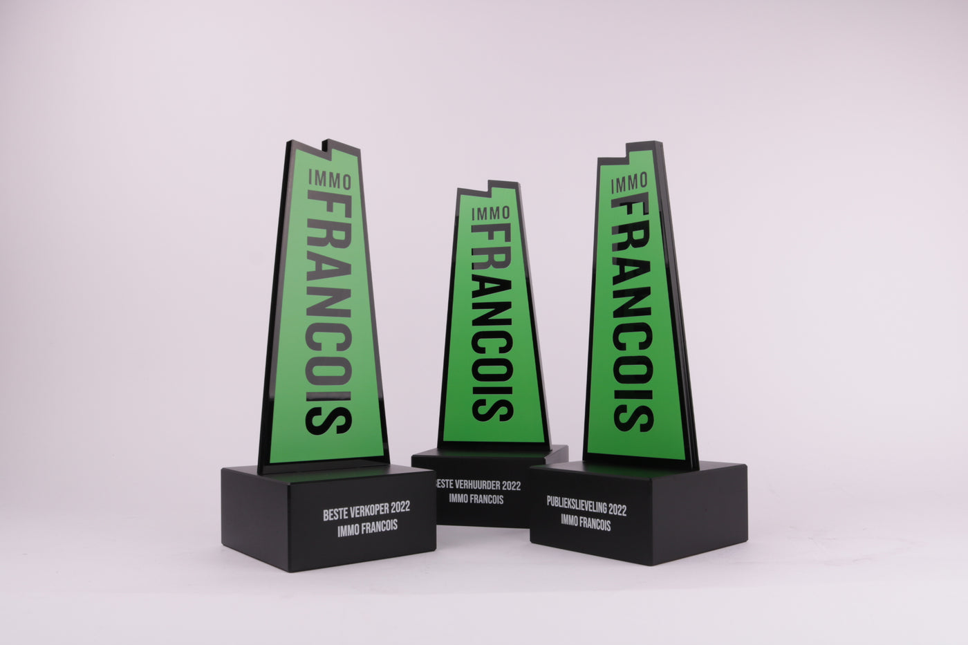 black trophy base with green 3d printed logo on top for immo Francois