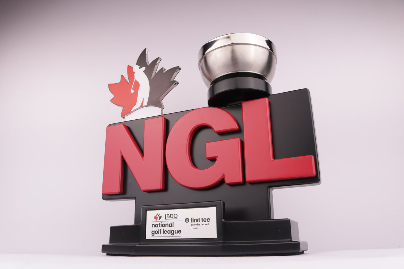 black trophy with 3d printed red logo and a 3d printed leaf