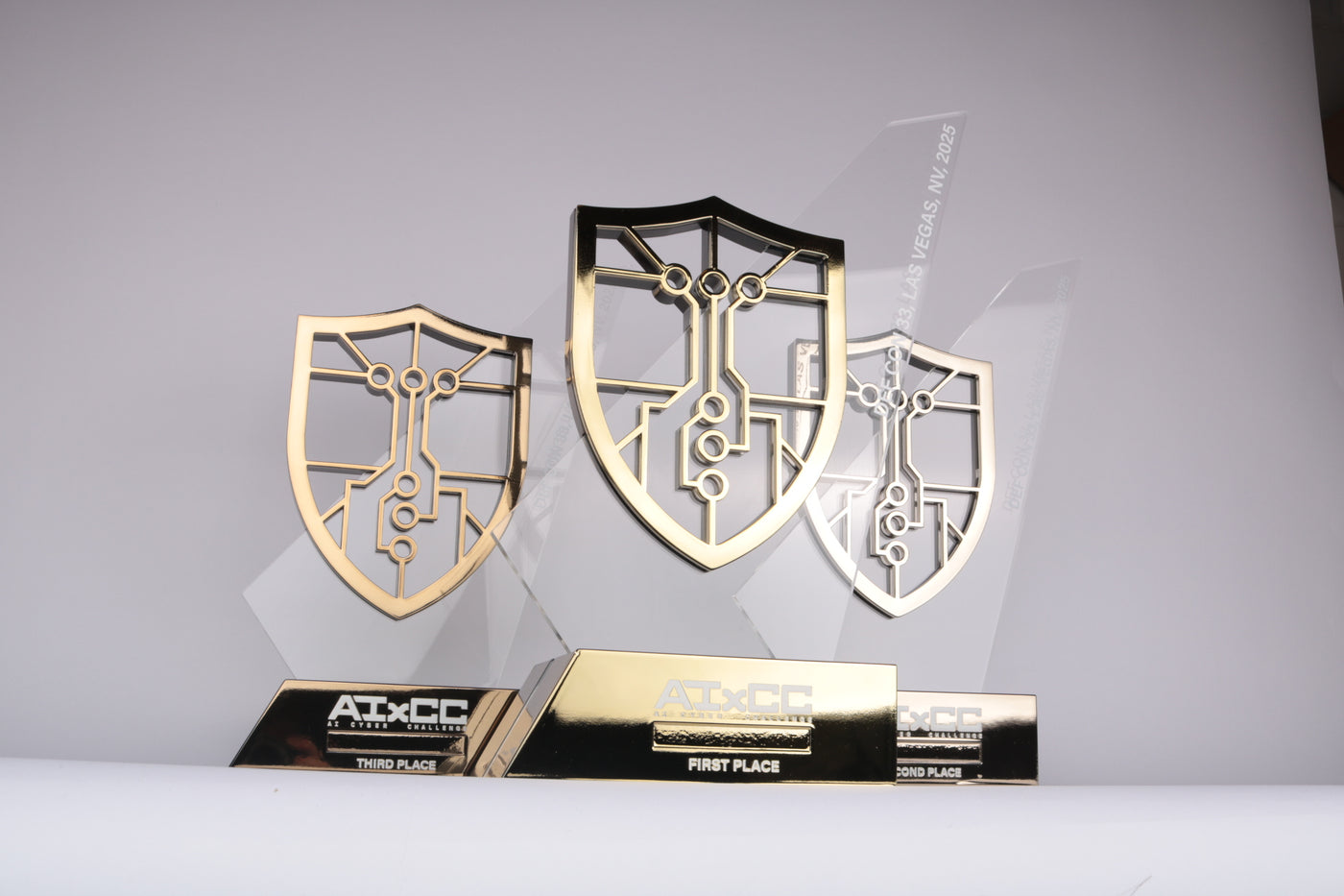 chrome gold, silver and bronze shields on acrylic plate on a chrome base with uv printed text