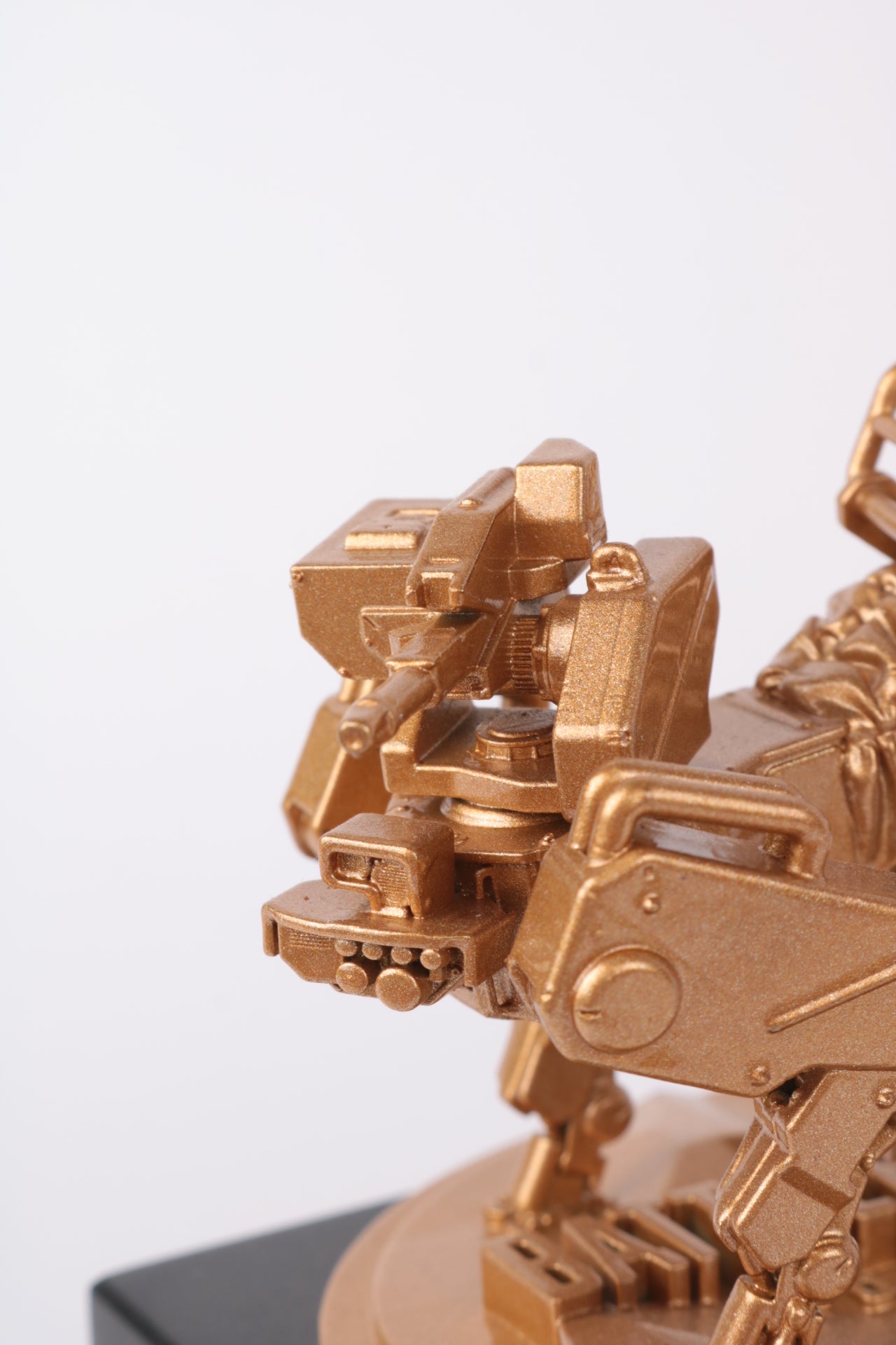 close-up of battlefield robot dog in game figurine in glossy gold metallic paint with details