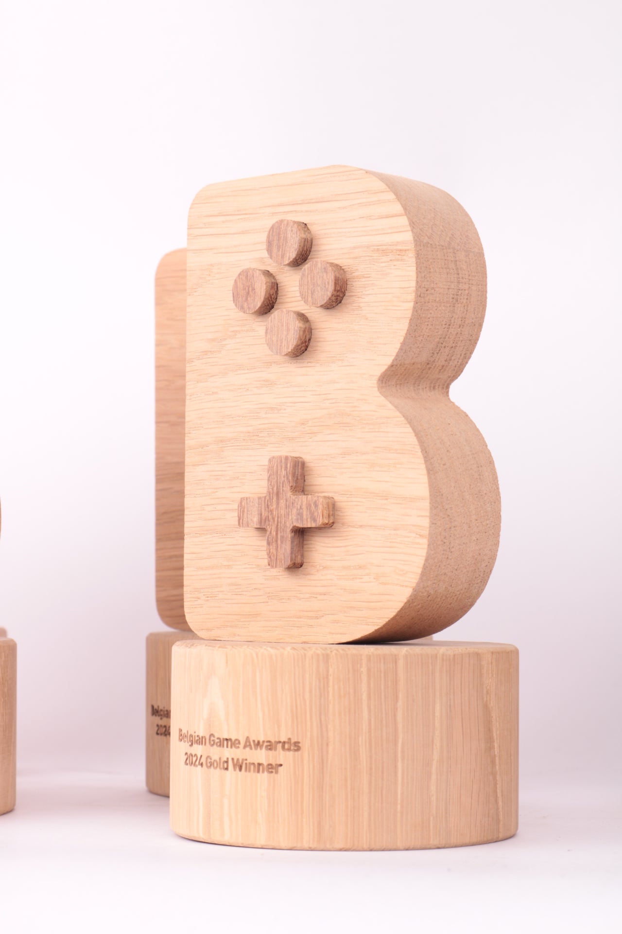 oak base for a game award with an oak controller shaped trophy