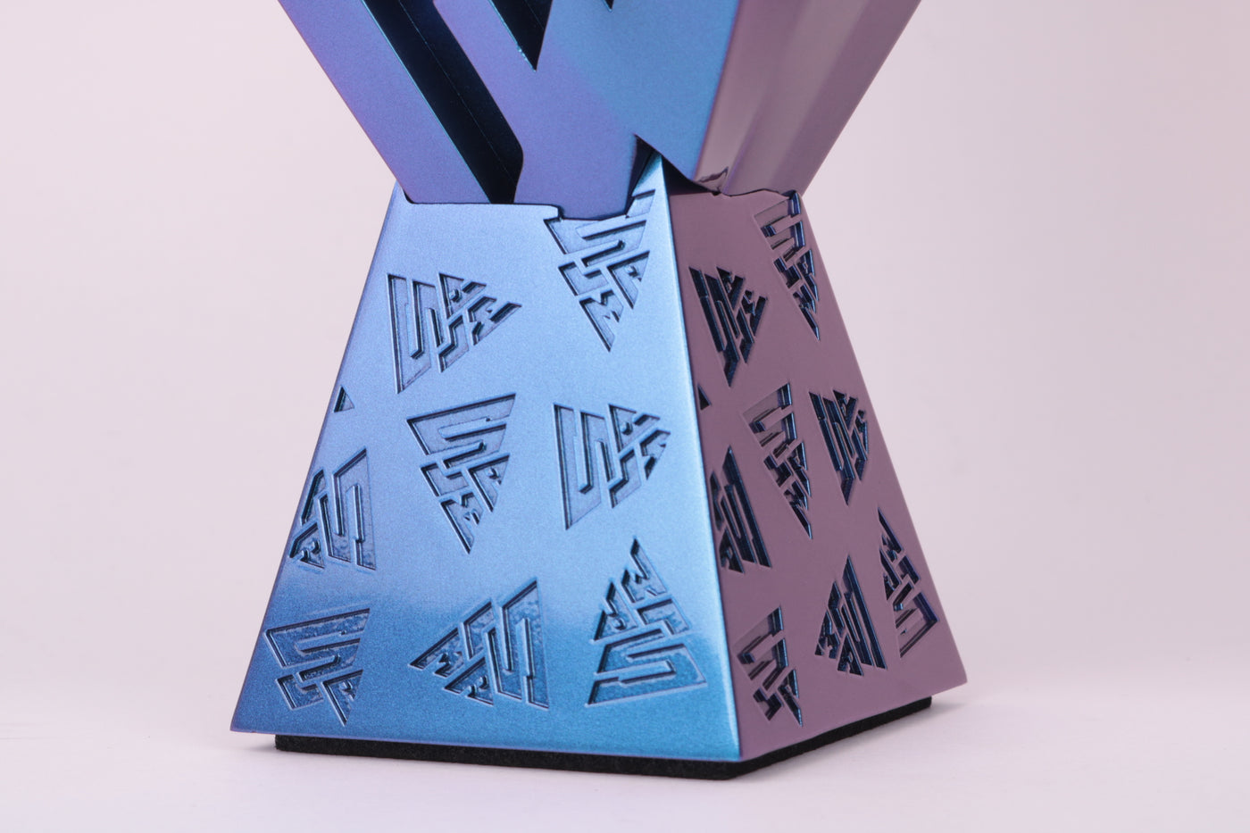 close up detail of logo embossed graphics on prism base in blue purple metallic chameleon paint