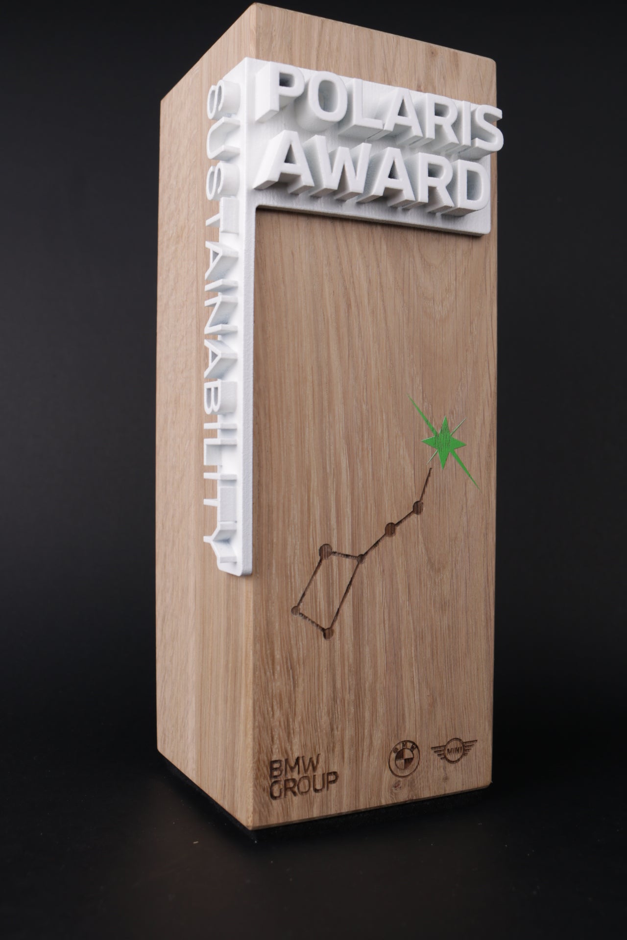 wooden trophy with a white 3d printed cornertext for bmw