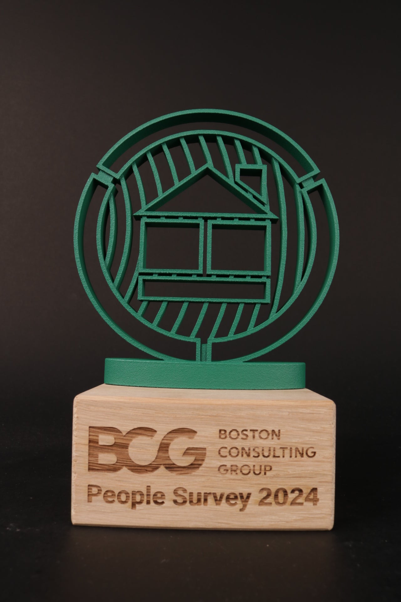 wood trophy stand with a 3d printed logo for boston consulting