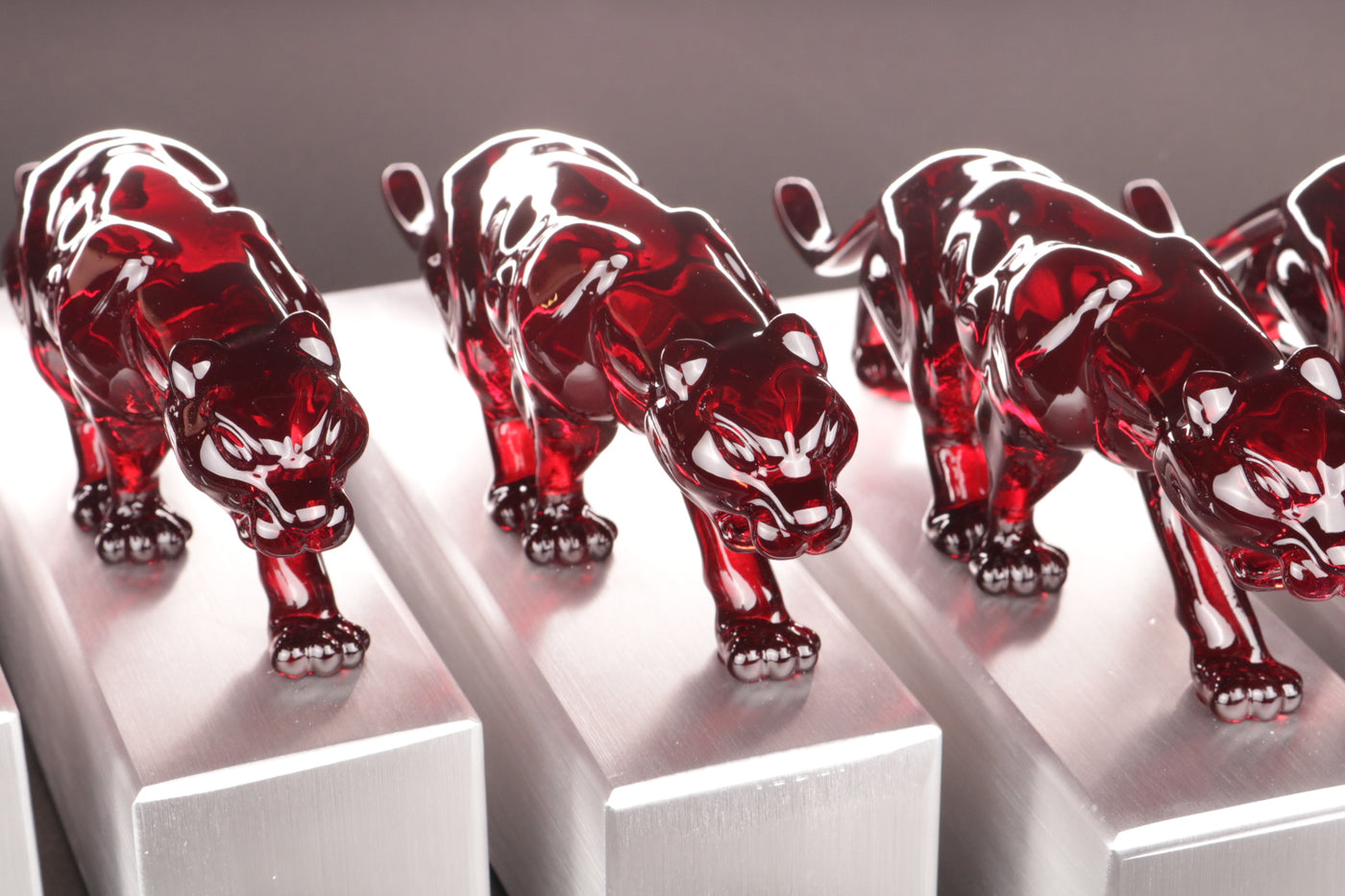 aluminium trophy stand with a glass red panter 
