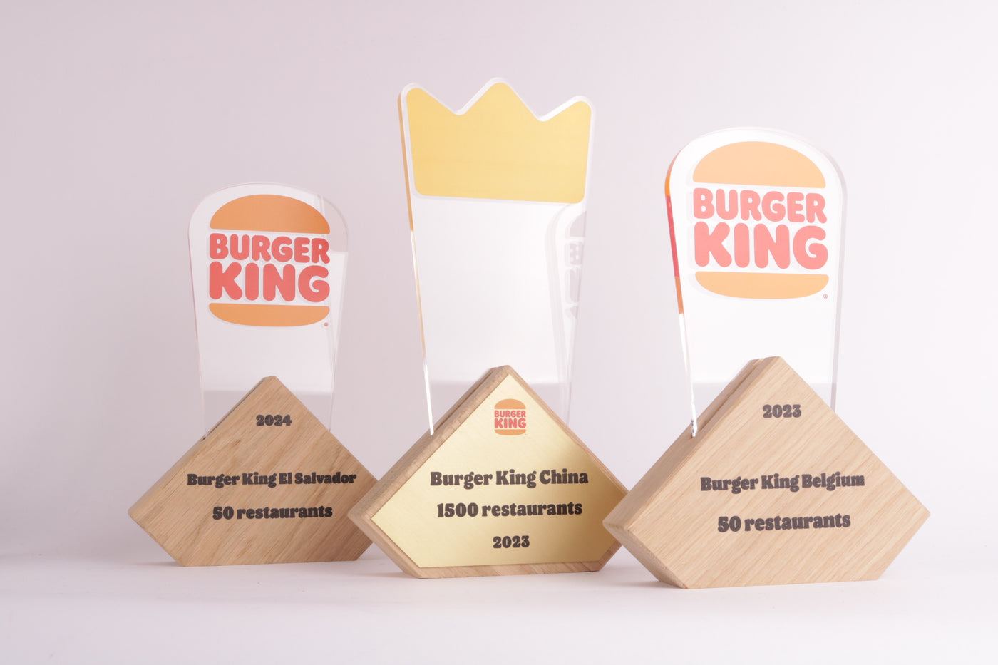 wooden triangular shaped trophy stand with an acrylic logo of burgerking