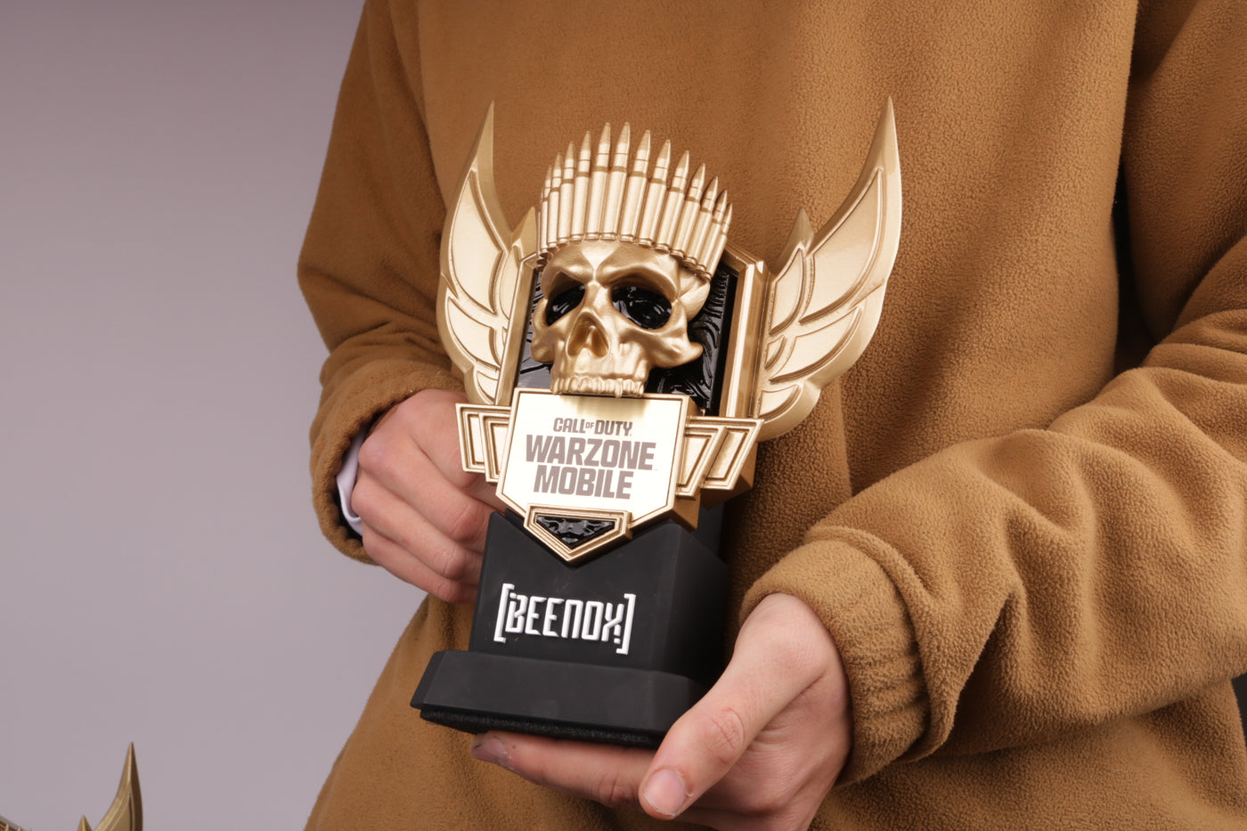 black based trophy with a gold skull, clean design