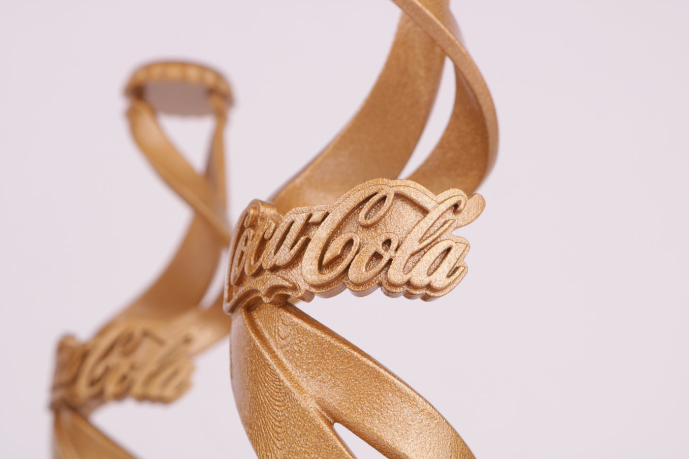 golden spiral shaped trophy for coca cola
