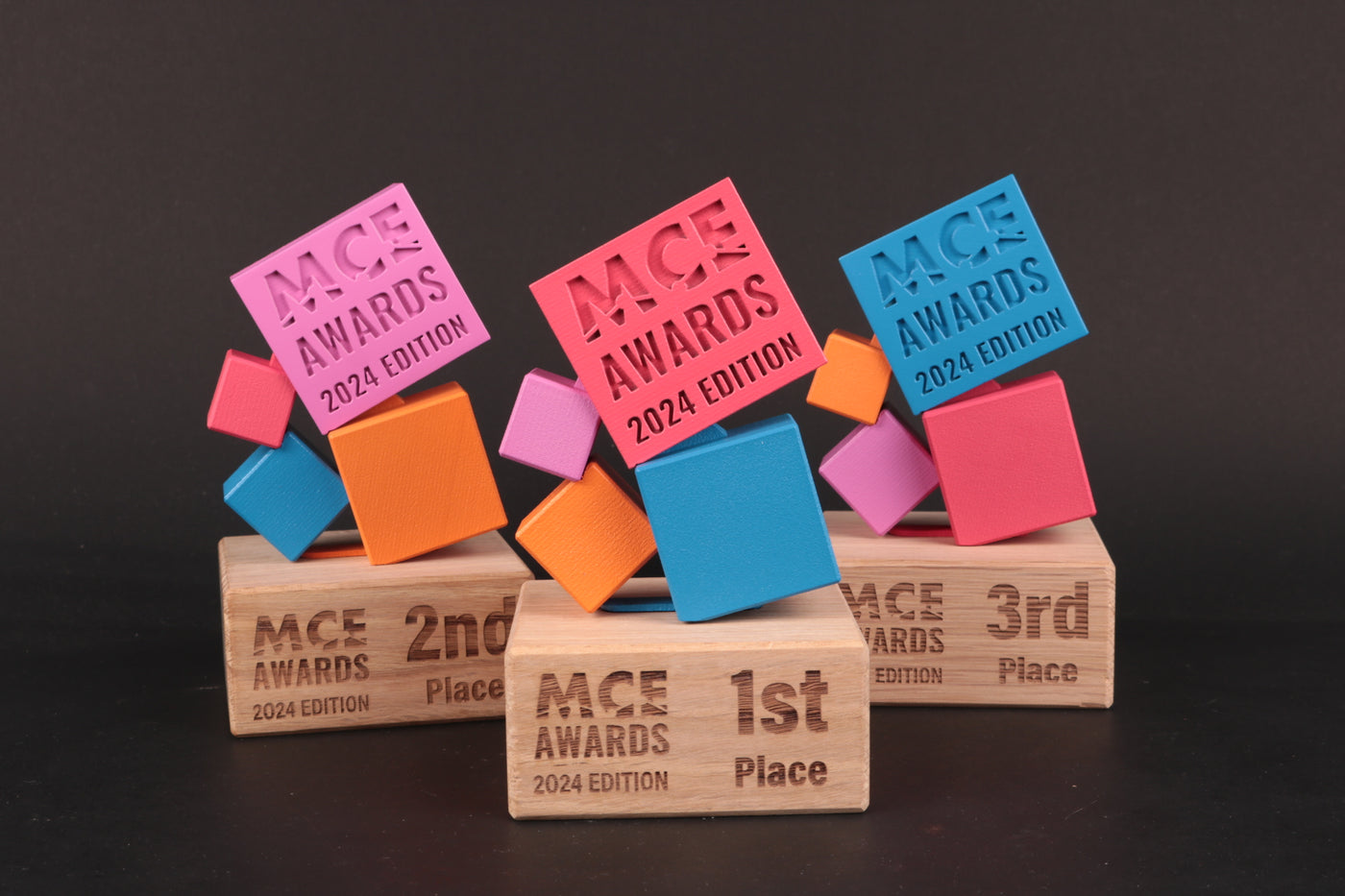 wooden trophy base with colorfull cubes as trophy for mce awards