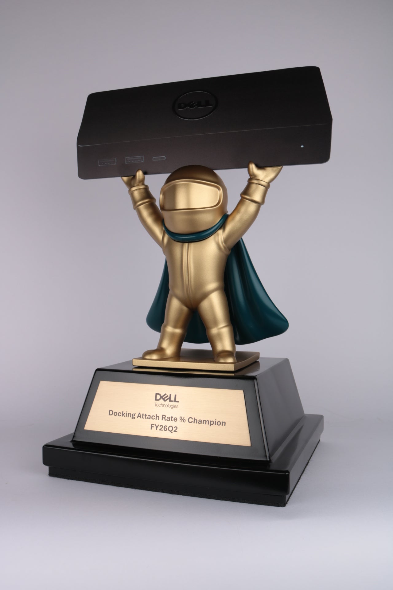 dell awards 3d printed figurine hero with cape holding device in satin gold paint on geometric base with brushed brass plaque