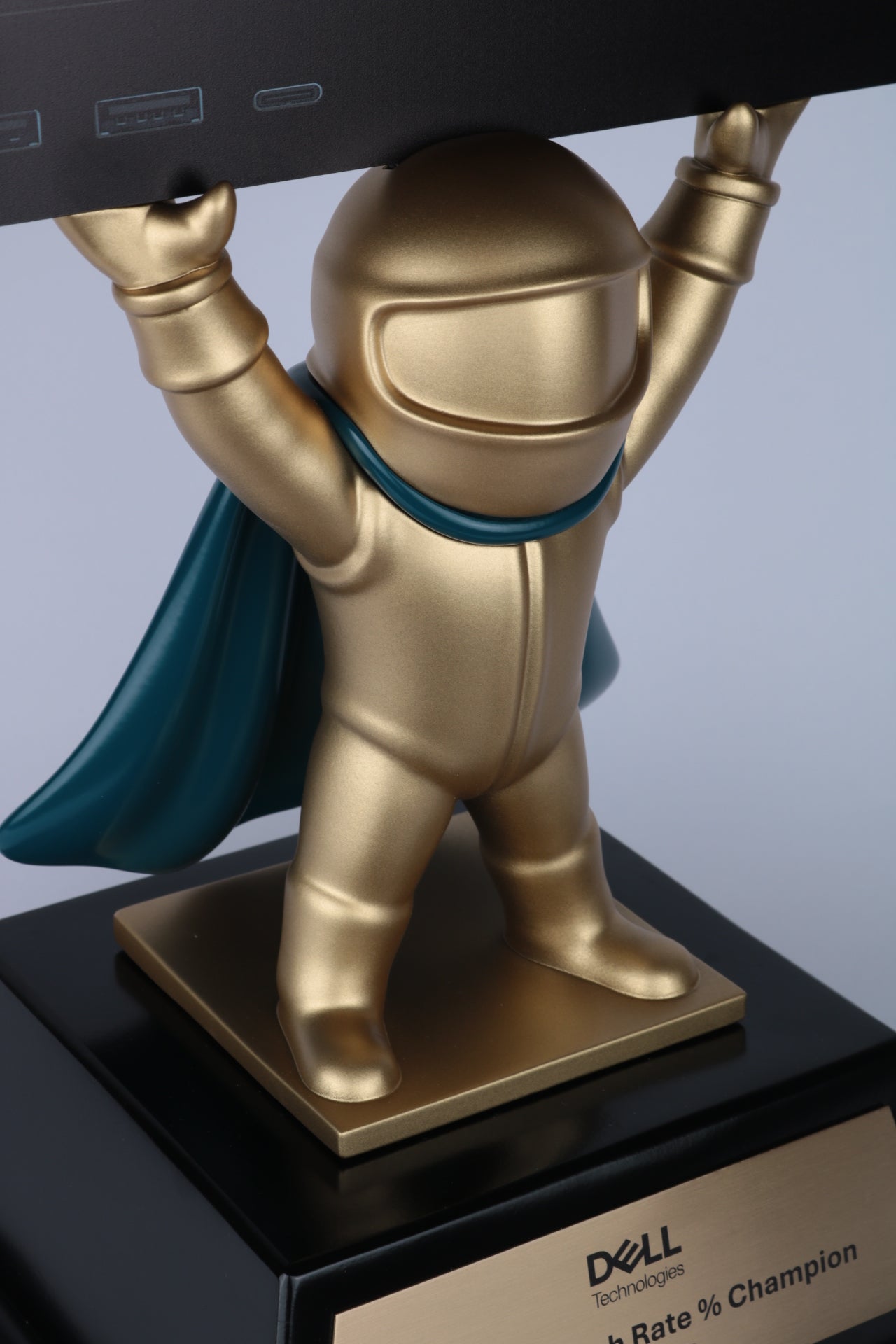 dell awards 3d printed figurine hero with cape holding device in satin gold paint on base with brushed brass plaque