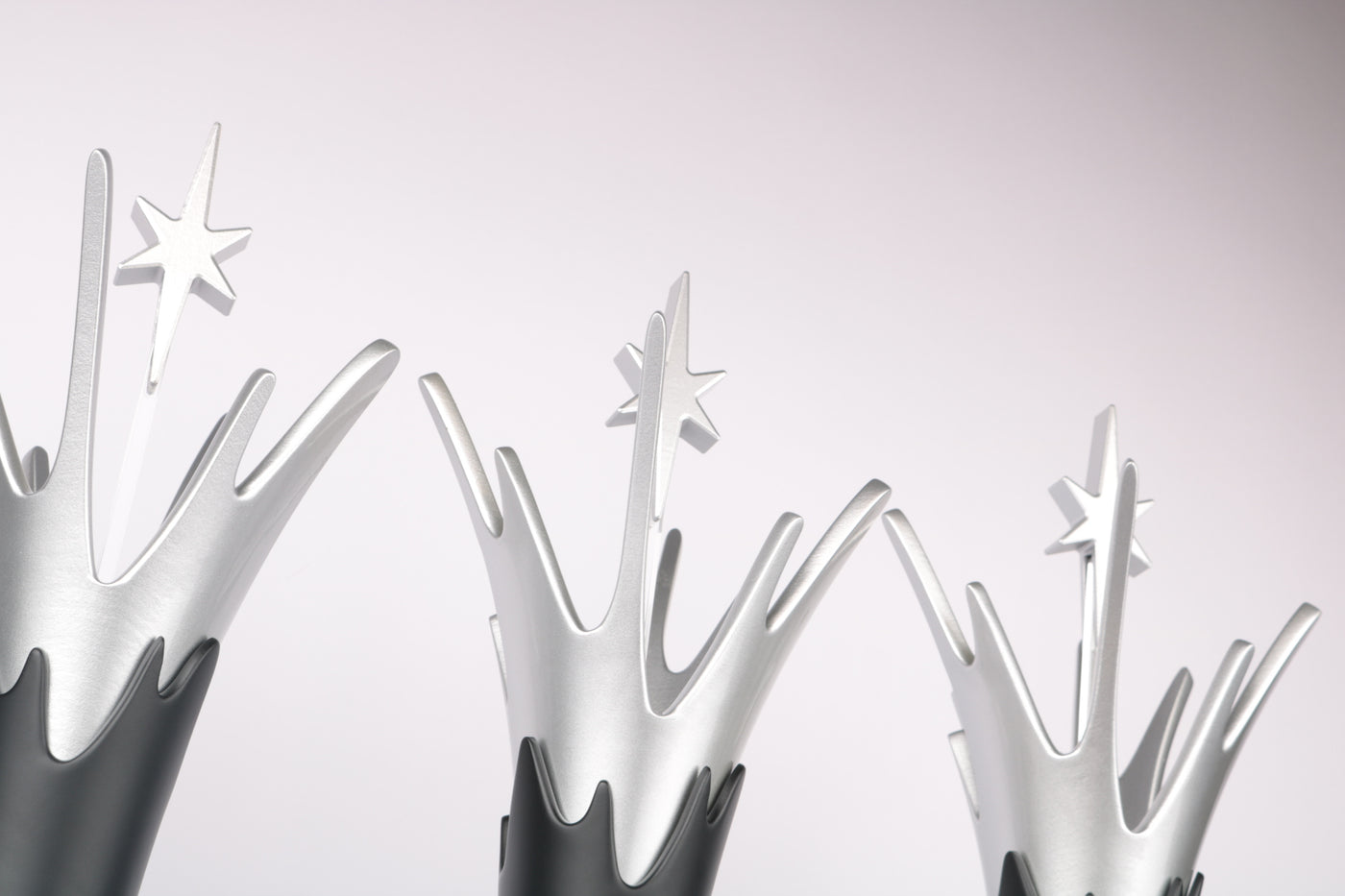 close-up of splash awards in satin silver paint with a floating star