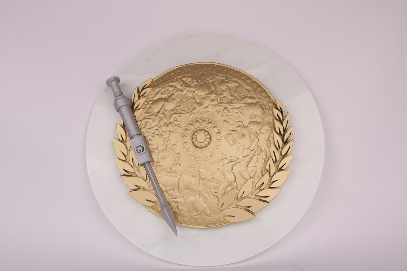 golden 3d printed shield with a silver looking 3d printed sword