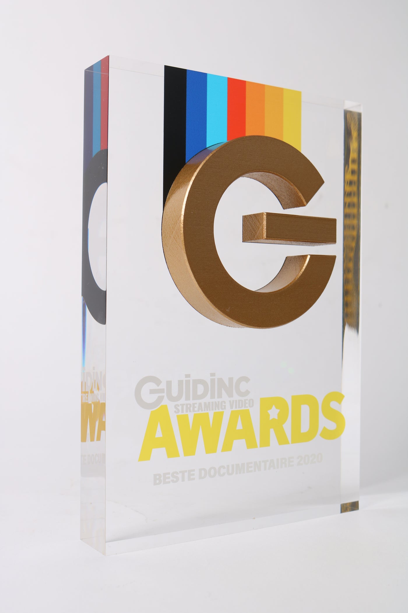 glass trophy with a golden 3d printed on-button 