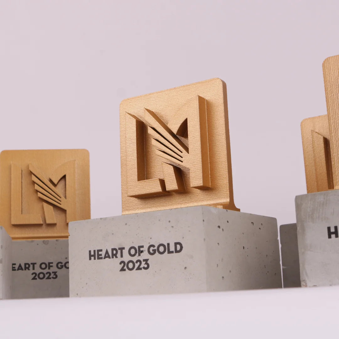 concrete base with a oak trophy on top for heart of gold