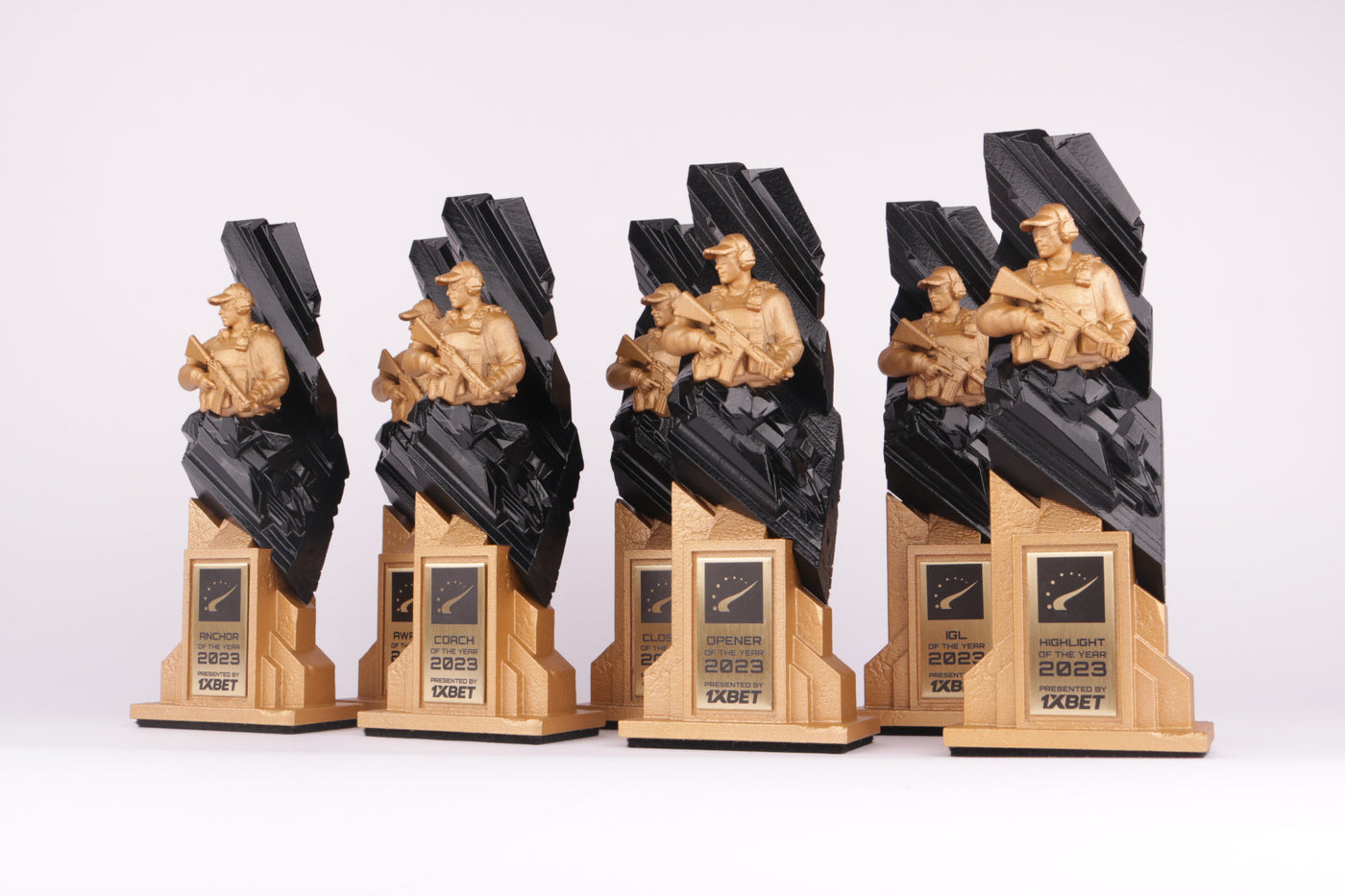 gold 3d printed trophy stand with a black and gold 3d printed trophy