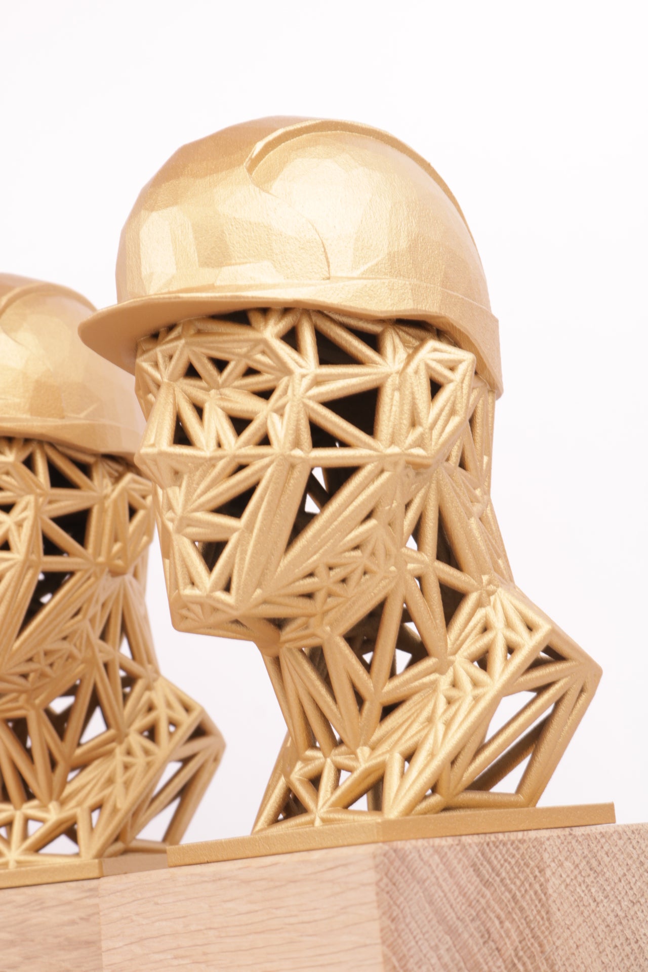 wooden trophy base with a golden 3d printed head on top