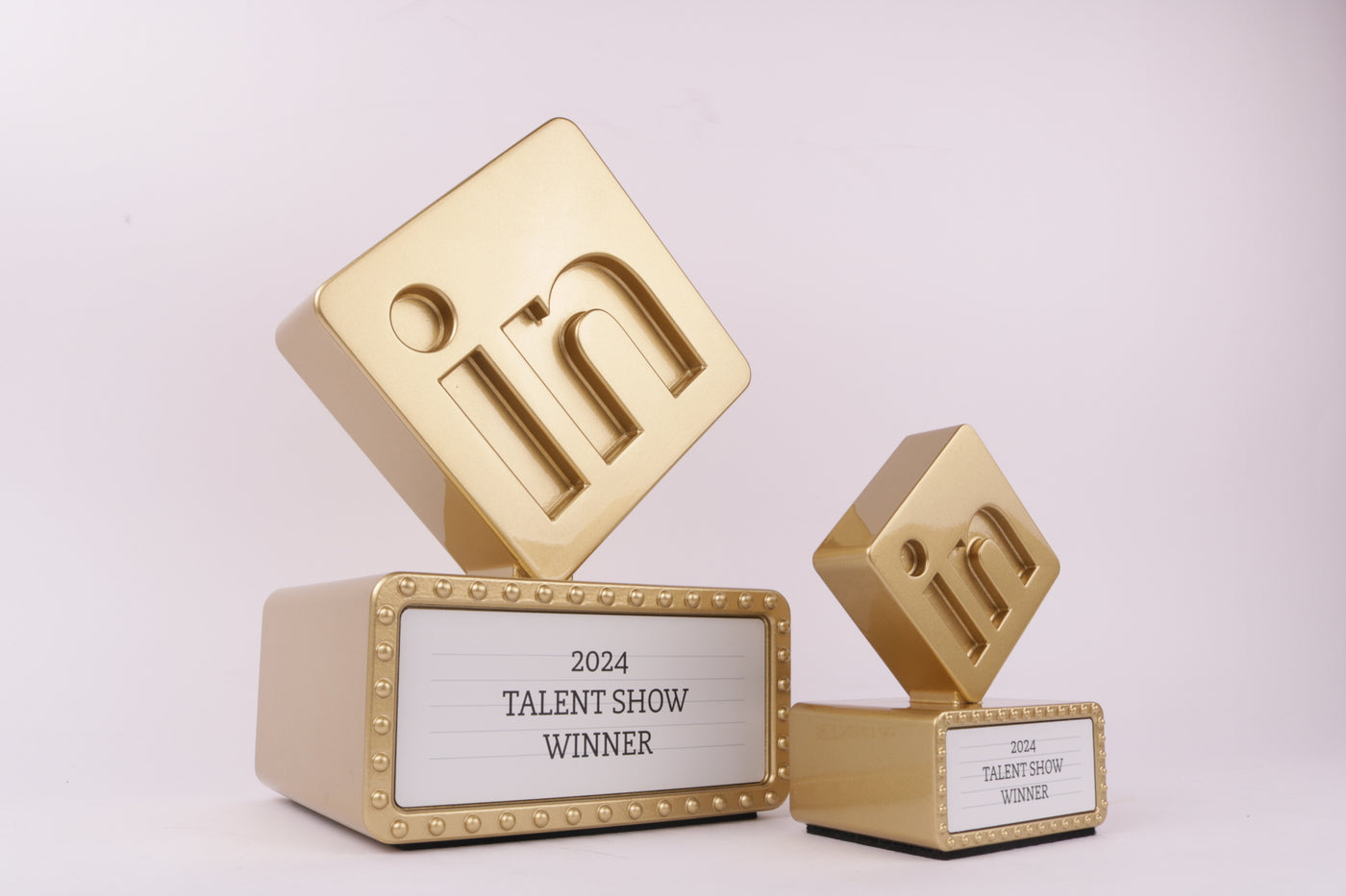 golden trophy base with a golden 3d printed trophy for linkedin