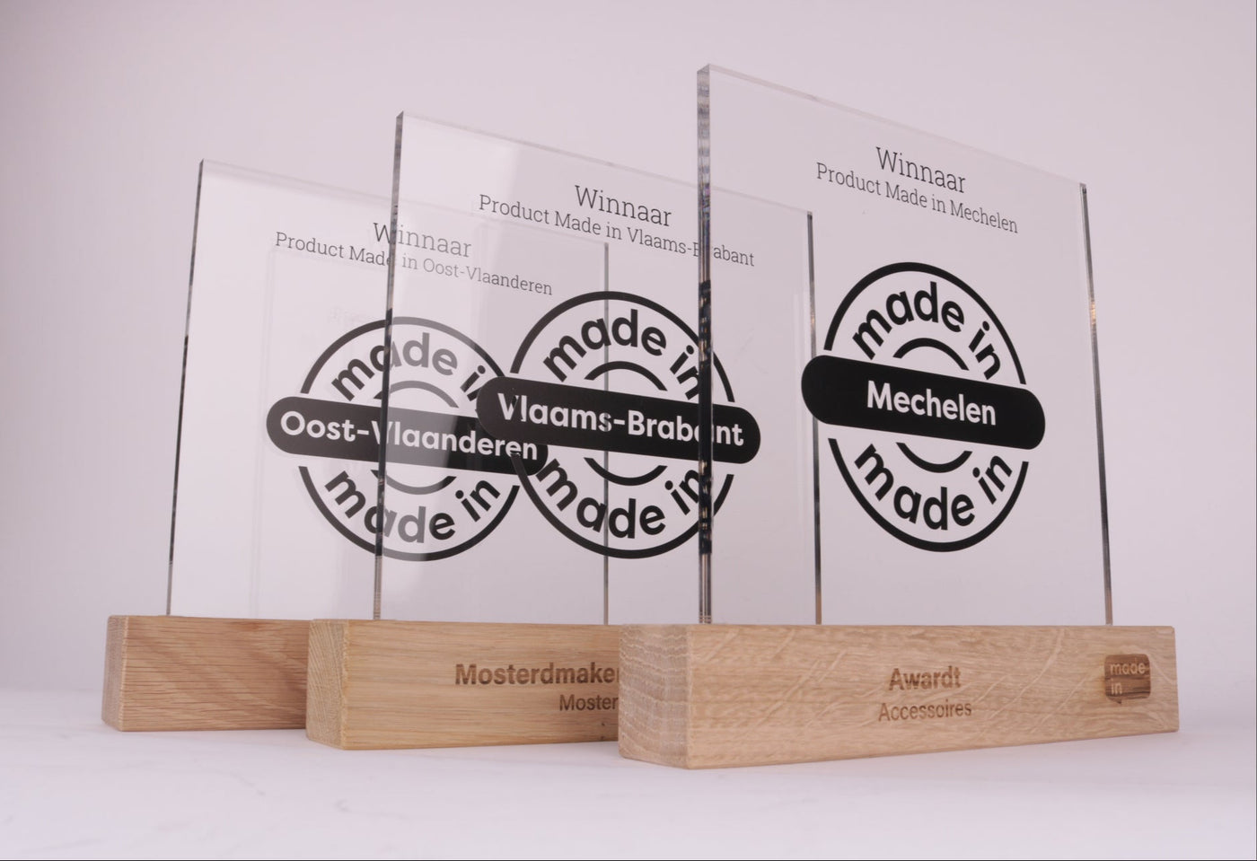 wooden trophy stand with an acrylic design of made in mechelen