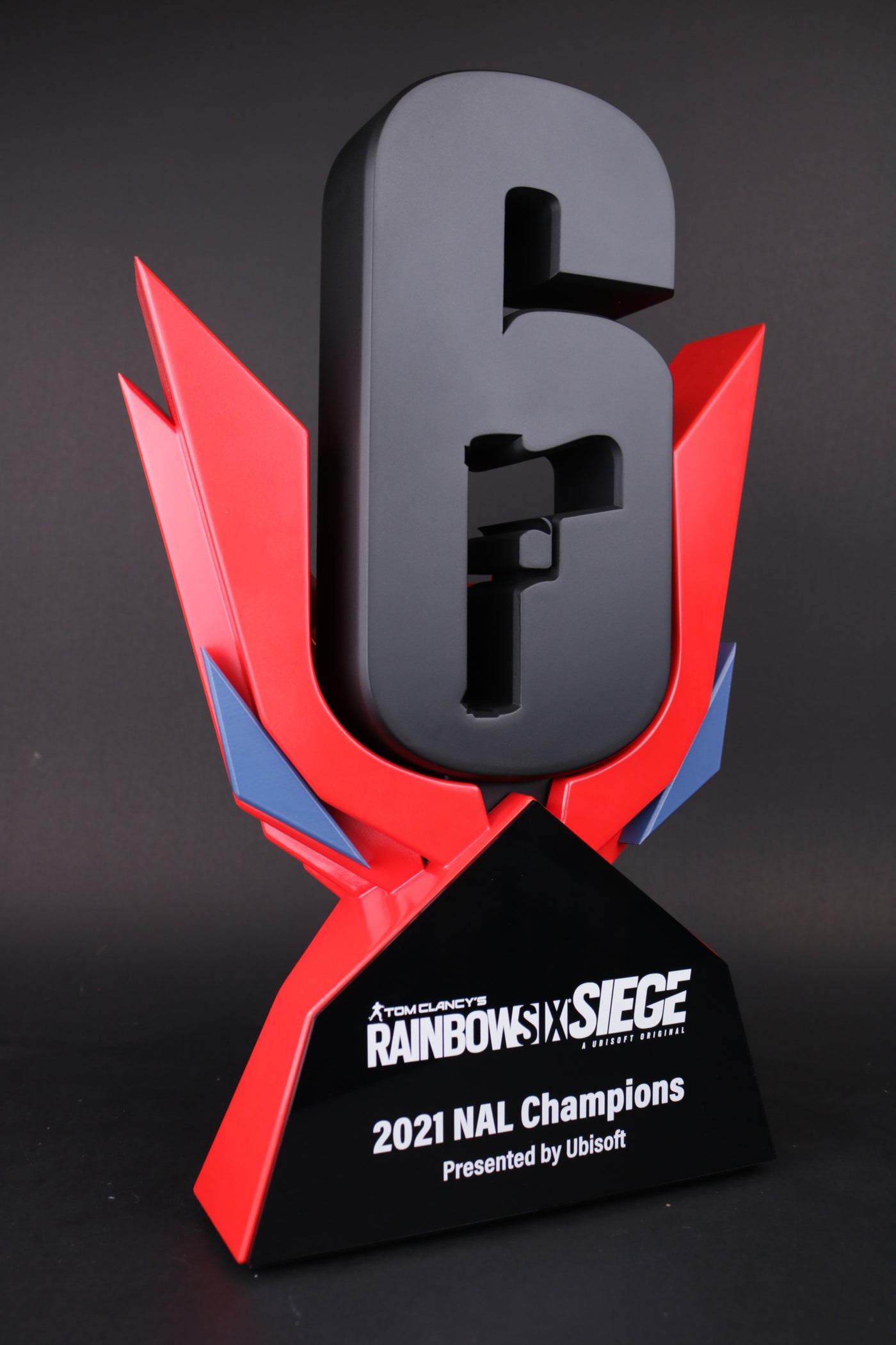 black and red 3d printed trophy stand with a 3d printed black six for ubisoft