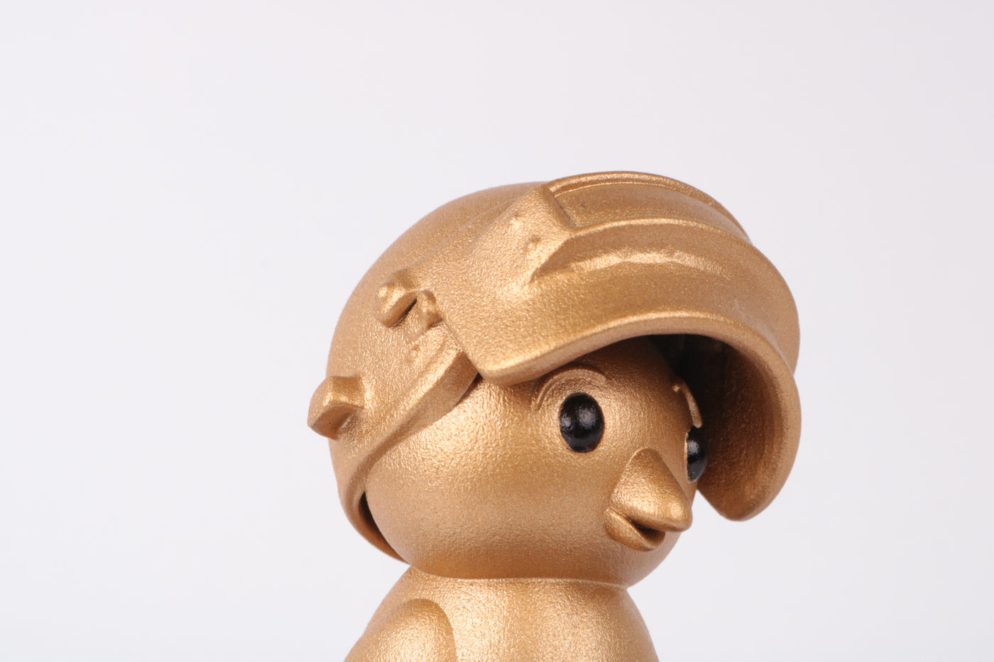 detail of pubg cute chick figurine with oversized helmet finished iņ satin gold paint