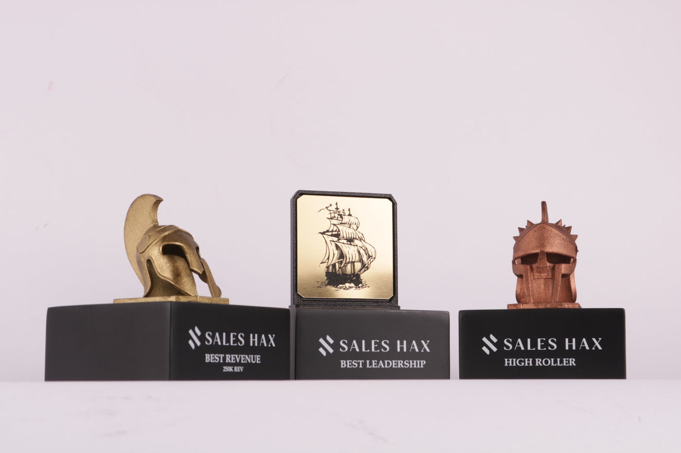 black trophy base with a bronze or gold helmet 