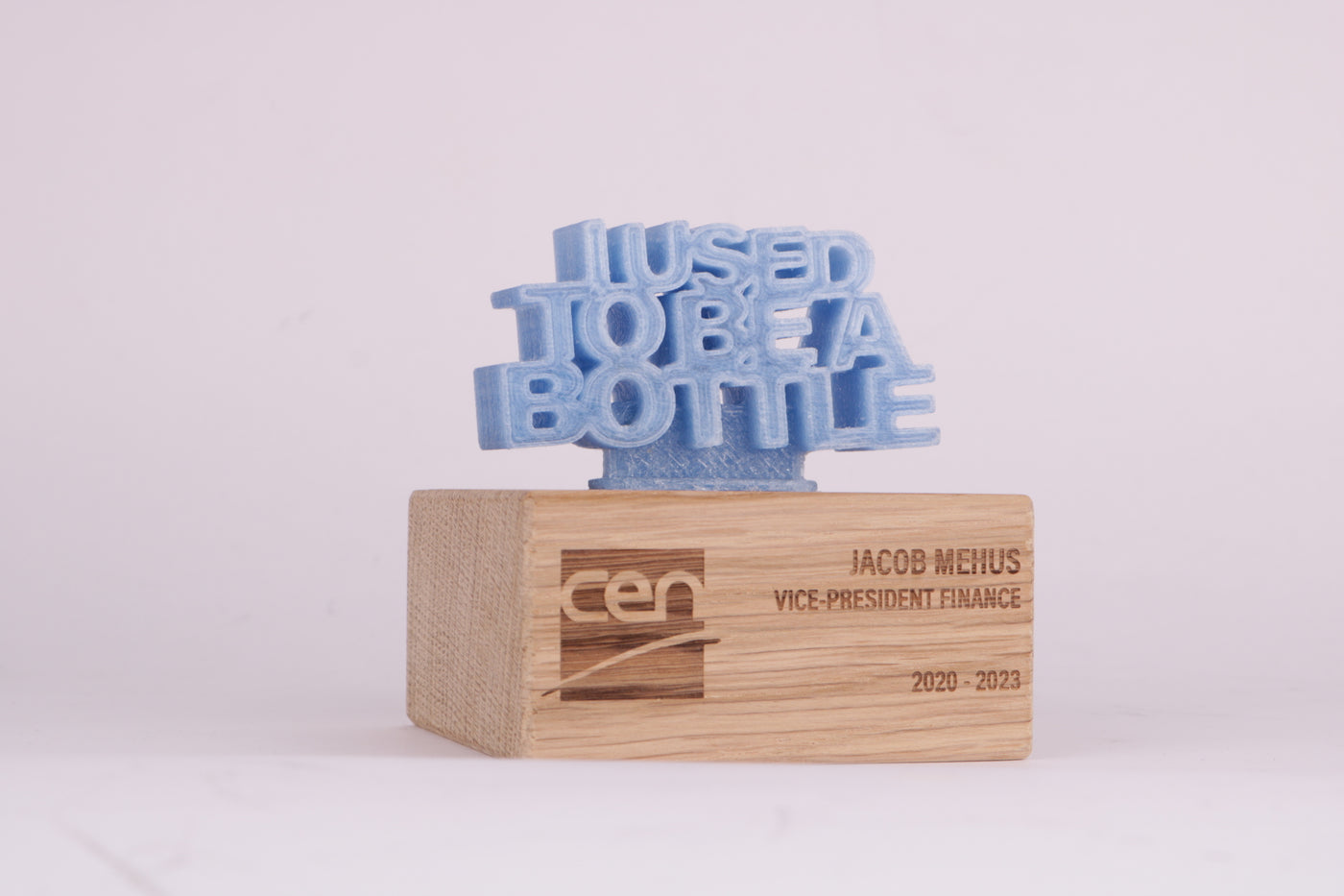wooden trophy base with a blue 3d printed text on top