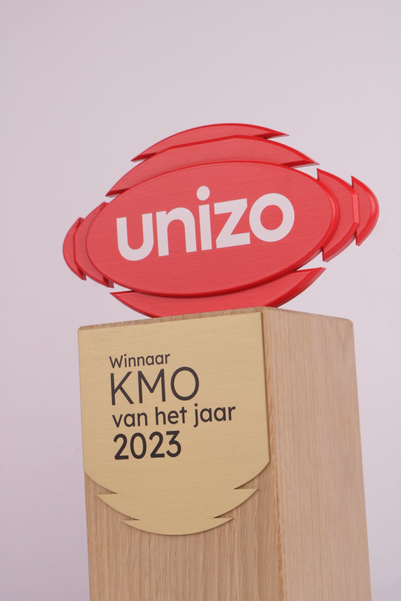 wooden trophy base with a red 3d printed logo on top