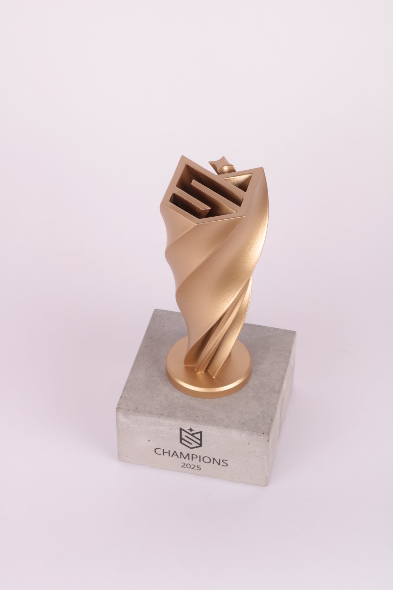concrete base with a gold twisty champions trophy