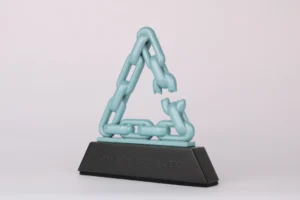 Fortra Chain Breakers corporate award with a mint green 3D printed broken chain triangle on a black base