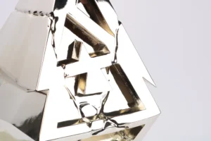 Close-up of the chrome silver BLAST Slam IV esports trophy with angular cutouts