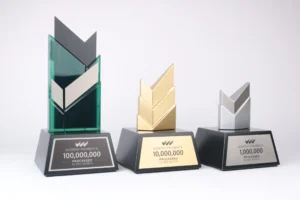 Three Worthy Payments milestone awards for 1, 10 and 100 million processed, with silver, gold and green chevrons