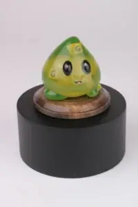 Green translucent slime mascot trophy on a wooden and black base