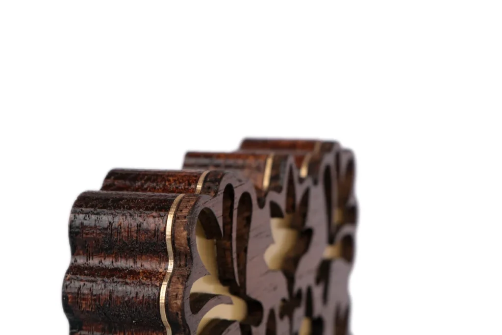 Edge detail of a stained oak award with brass inlay